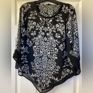 Black and off-white damask print top with beaded neckline, sheer cuffs and hem.